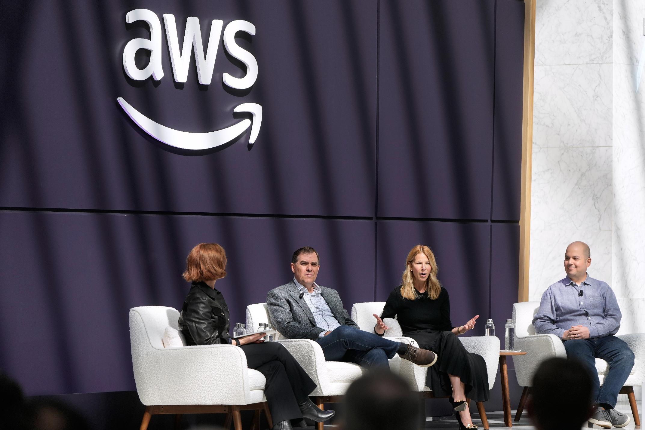 Denise Dresser, chief revenue officer of OpenAI, second right, speaks on stage with Julia White, vice president & chief marketing officer, AWS, from left, Matt Garman, CEO of AWS, and Anthony Liguori, vice president and distinguished engineer, AWS, at a What's Next with AWS event, Tuesday, April 28, 2026, in San Francisco. (AP Photo/Jeff Chiu)