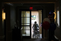 FILE - A woman uses a walker as she exits an assisted living building, July 4, 2025, in Boca Raton, Fla. (AP Photo/Rebecca Blackwell, File)