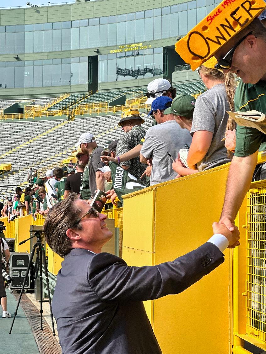 New Green Bay Packers president/CEO Ed Policy greets fans after the NFL football team's annual shareholders meeting, Friday, July 25, 2025, in Green Bay, Wis. (AP Photo/Steve Megargee)