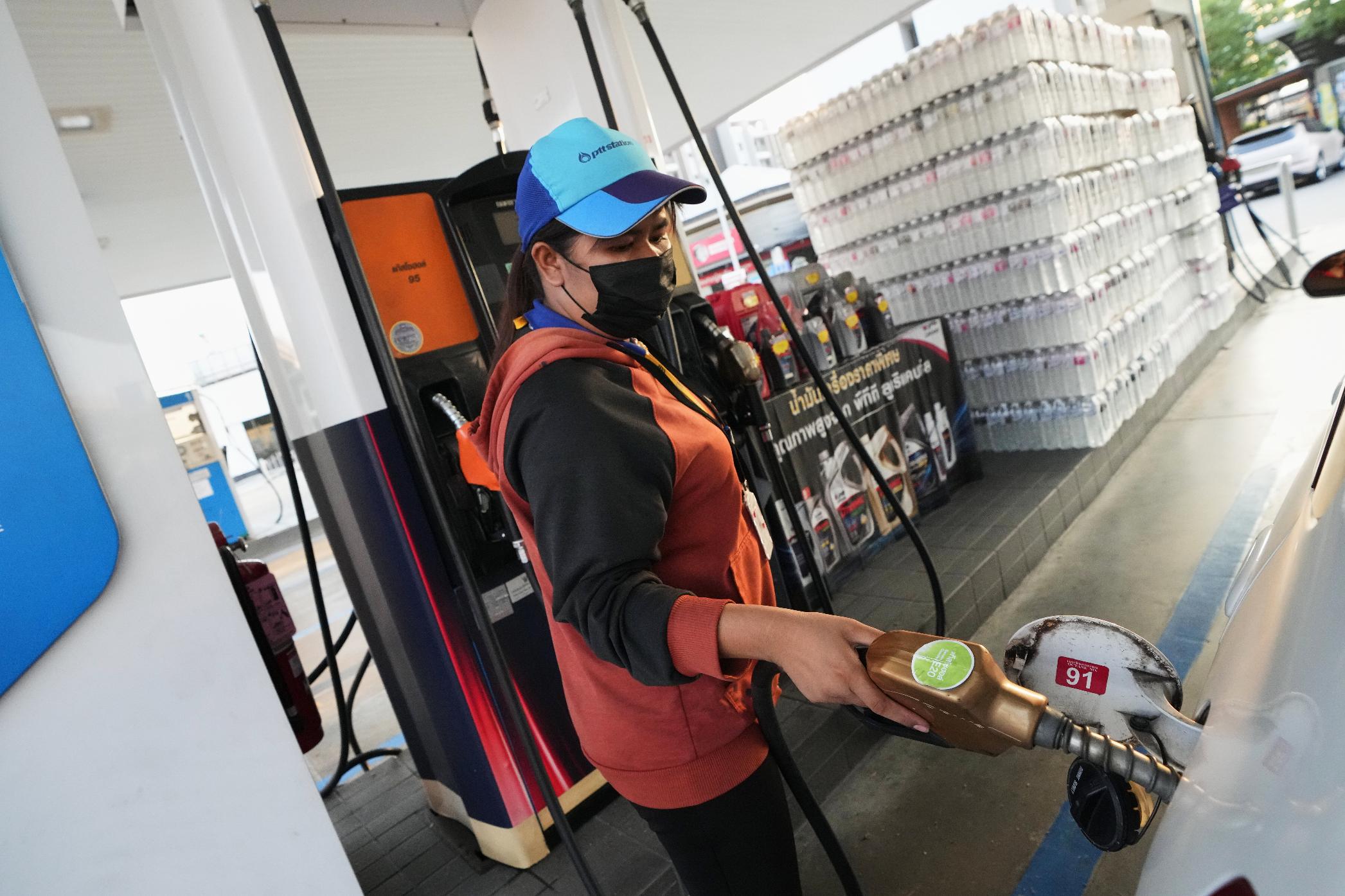 A gas station attendant fills the tank of a car in Bangkok, Thailand, Monday, March 9, 2026. (AP Photo/Sakchai Lalit)