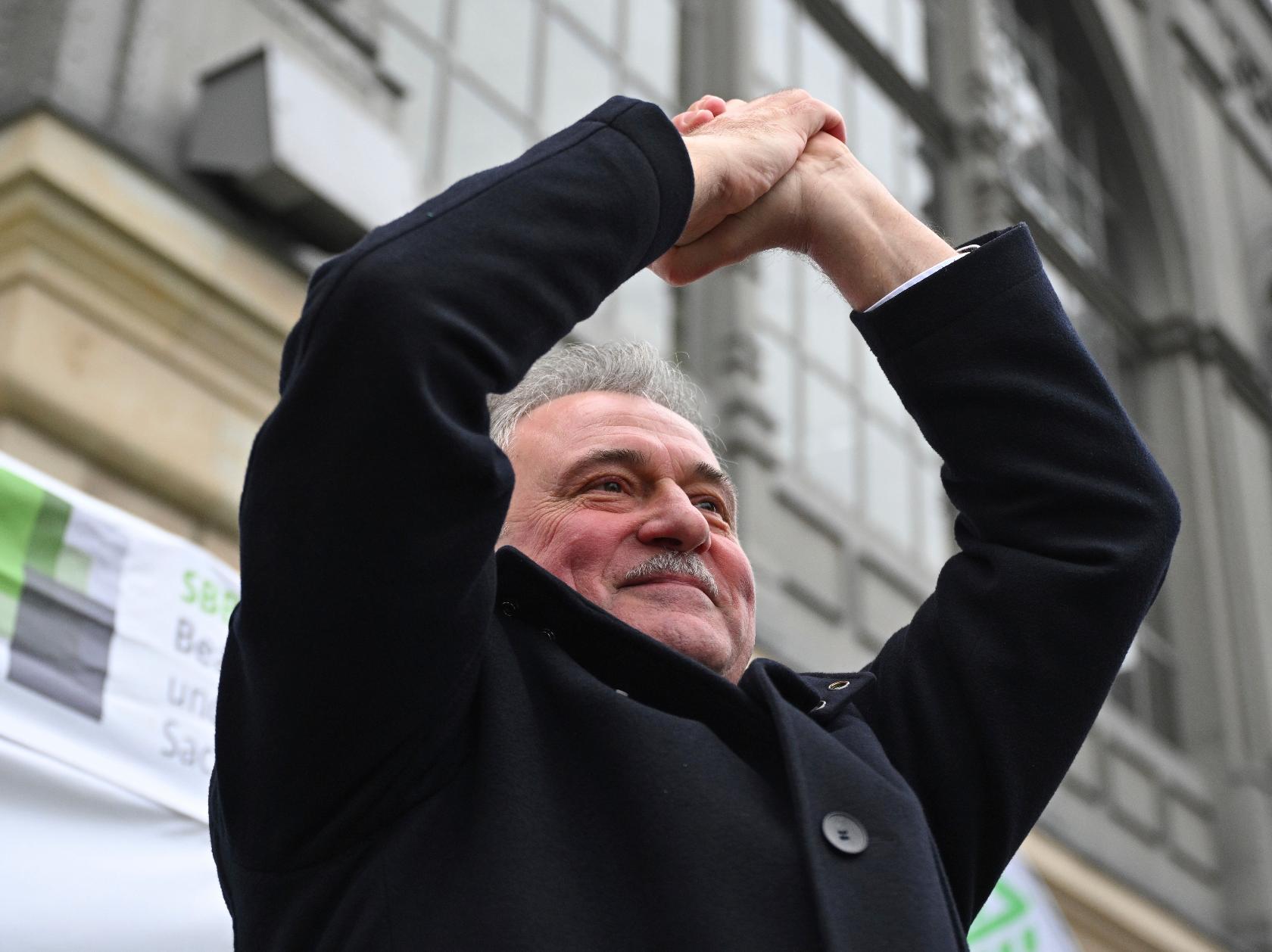 Chairman of the German Train Drivers' Union (GDL) Claus Weselsky cheers after his speech to GDL members at a rally in front of the main railway station, in Dresden, Germany, Friday Jan. 26, 2024. The German Train Drivers' Union (GDL) has called for another strike at Deutsche Bahn lasting several days. It is the fourth and by far the longest industrial action in the ongoing wage dispute at Deutsche Bahn. (Robert Michael/dpa via AP)