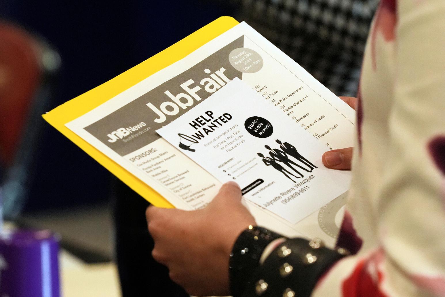 A job seeker waits to talk to a recruiter at a job fair Thursday, Aug. 28, 2025, in Sunrise, Fla. (AP Photo/Marta Lavandier)