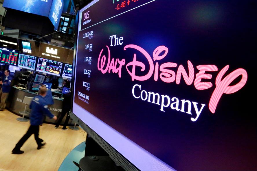 FILE - In this Aug. 8, 2017, file photo, The Walt Disney Co. logo appears on a screen above the floor of the New York Stock Exchange. (AP Photo/Richard Drew, File)