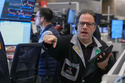 Options trader Anthony Spina works on the floor of the New York Stock Exchange, Friday, Feb. 13, 2026, in New York. (AP Photo/Richard Drew)