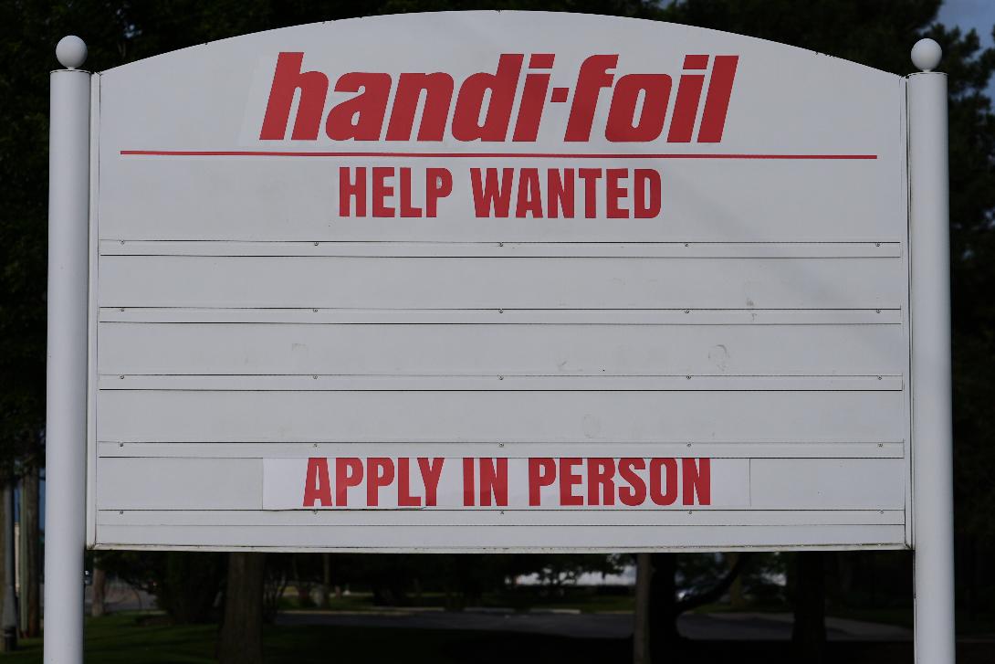 A help wanted sign is seen outside of a company in Wheeling, Ill., Monday, June 8, 2026. (AP Photo/Nam Y. Huh)