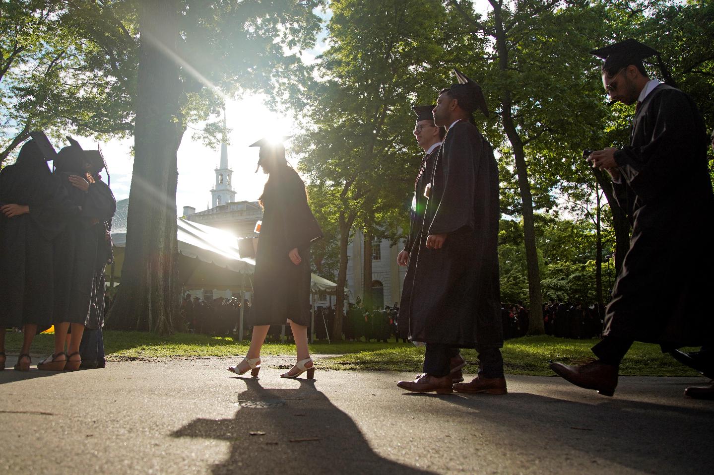 FILE - Graduates walk at a Harvard Commencement ceremony held for the classes of 2020 and 2021, May 29, 2022, in Cambridge, Mass. The Supreme Court is about to hear arguments over President Joe Biden’s student debt relief plan. It's a plan that impacts millions of borrowers who could see their loans wiped away or reduced. (AP Photo/Mary Schwalm, File)