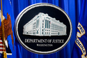 The U.S. Department of Justice logo is before a news conference, Monday, May 4, 2026, in Washington. (AP Photo/Julia Demaree Nikhinson)
