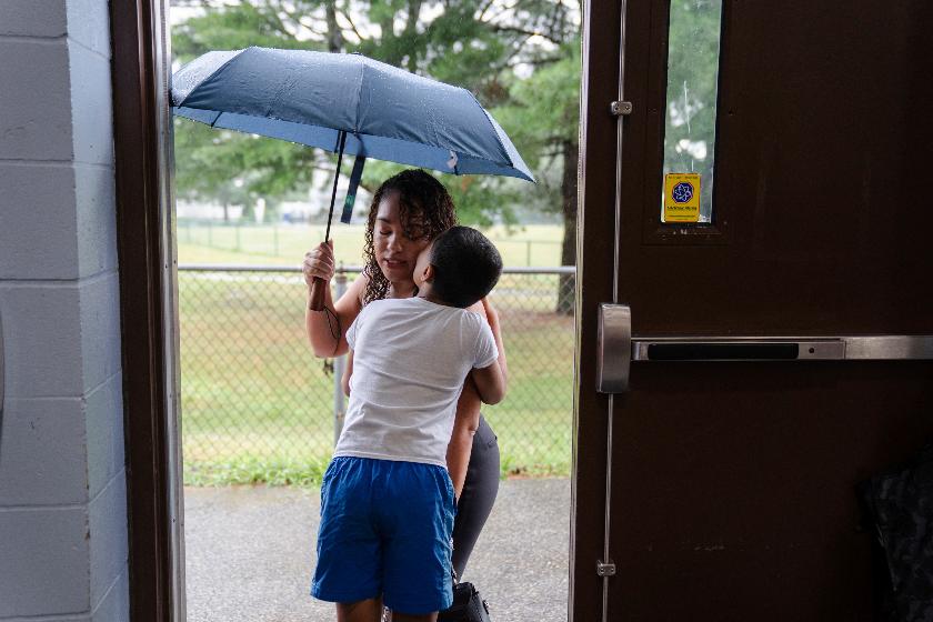 Darleen Reyes drops her son, Aiden Caceres, 8, off at the East Providence Boys and Girls Club Summer Camp at Emma G. Whiteknact Elementary School on Thursday, July 10, 2025, in Providence R.I. (AP Photo/Sophie Park)