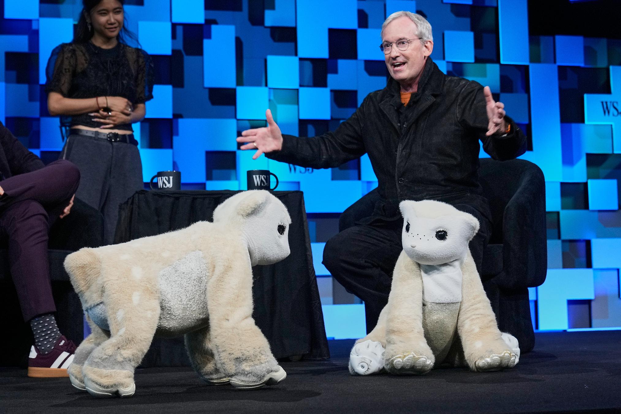 Colin Angle, longtime CEO of Roomba, unveils a four-legged prototype of artificial pets Winston, left, and Daphne, called Familiars, at The WSJ Future of Everything, in New York, Monday, May 4, 2026. (AP Photo/Richard Drew)