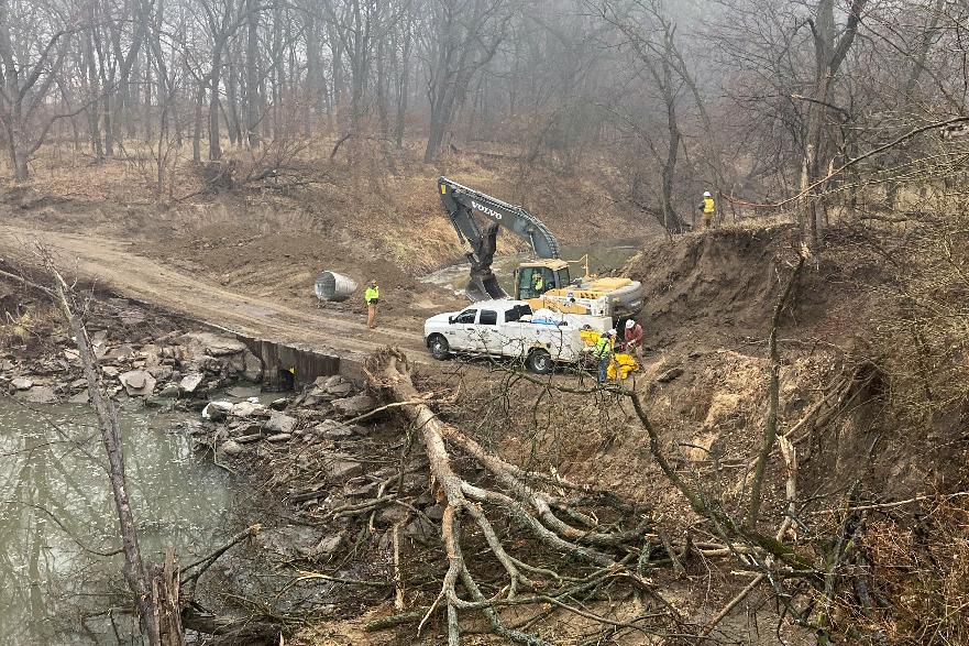 Washington County Road Department constructs an emergency dam to intercept an oil spill after a Keystone pipeline ruptured at Mill Creek in Washington County, Kanas, on Thursday, Dec 8, 2022. Vacuum trucks, booms and an emergency dam were constructed on the creek to intercept the spill. (Kyle Bauer/KCLY/KFRM Radio via AP)