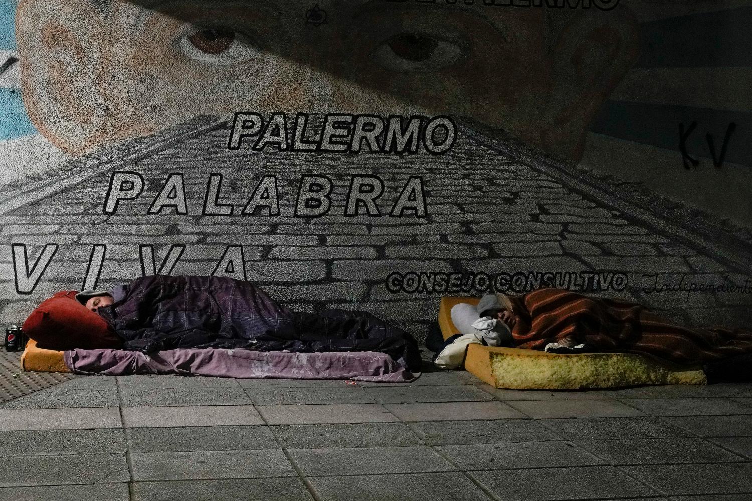 Homeless people sleep on a sidewalk in Buenos Aires, Argentina, Wednesday, early Sept. 27, 2023. (AP Photo/Natacha Pisarenko)