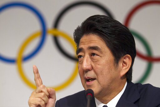 FILE - Then Japan's Prime Minister Shinzo Abe gestures during a news conference at the 125th International Olympic Committee session in Buenos Aires, Argentina on Sept. 7, 2013.  Former Japanese Prime Minister Abe, a divisive arch-conservative and one of his nation's most powerful and influential figures, has died after being shot during a campaign speech Friday, July 8, 2022, in western Japan, hospital officials said.(AP Photo/Ivan Fernandez, File)