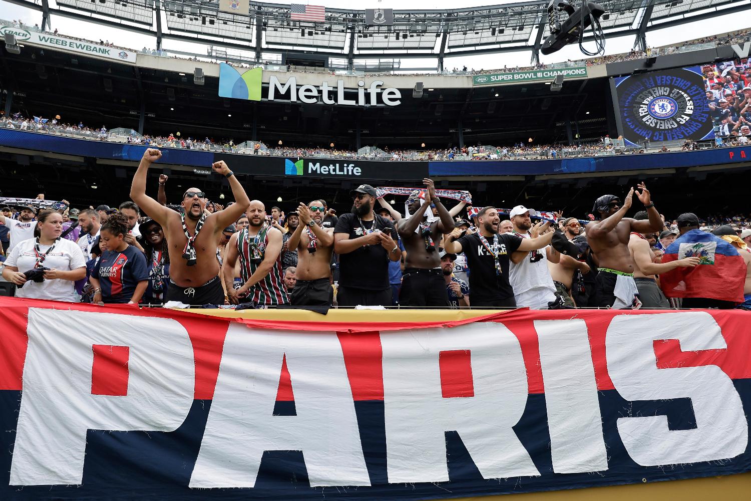 FILE - PSG fans cheer before the start of the Club World Cup final soccer match between Chelsea and PSG in East Rutherford, N.J., Sunday, July 13, 2025. (AP Photo/Adam Hunger, File)