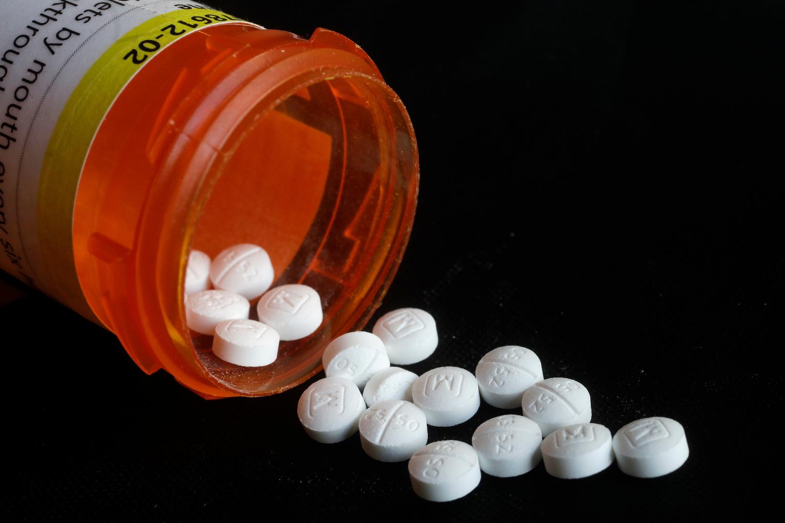 FILE - Pills spill in an arrangement photo of prescription Oxycodone in New York. (AP Photo/Mark Lennihan, File)