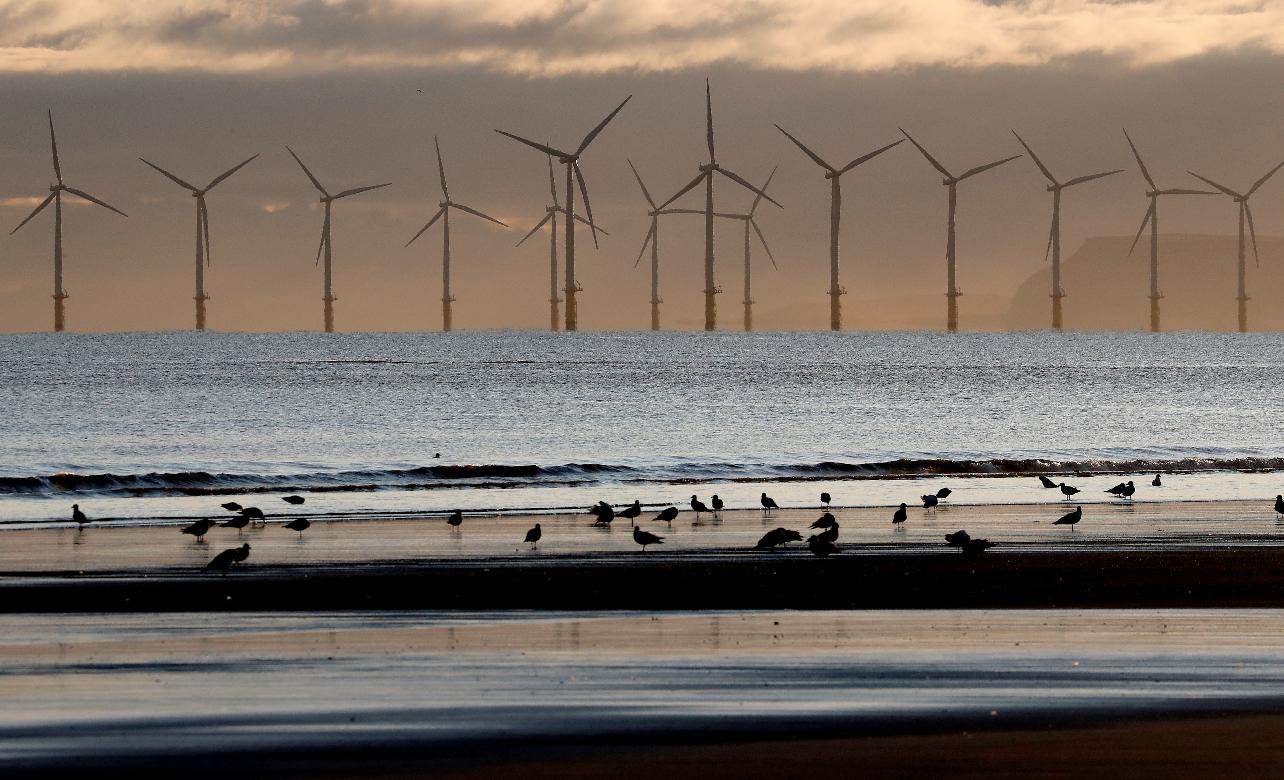 FILE - An offshore wind farm is visible from the beach in Hartlepool, England, Tuesday, Nov. 12, 2019. (AP Photo/Frank Augstein, File)