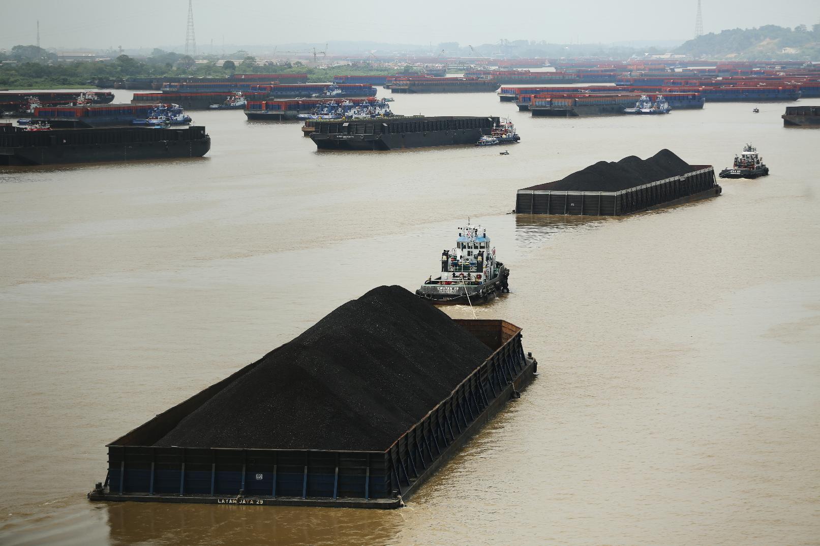 Tug boats pull barges loaded with coal on Mahakam River in Samarinda, East Kalimantan, Indonesia, on Aug. 19, 2026. (AP Photo/Ahmad Mulia Panjaitan)