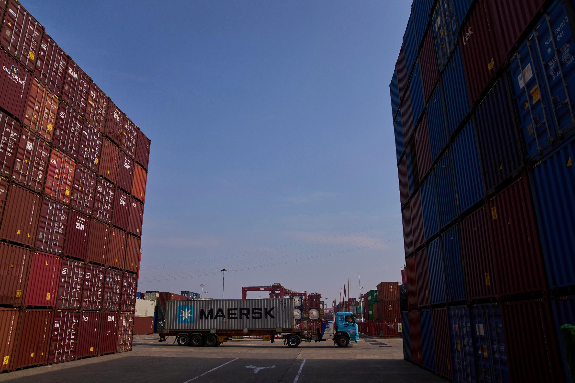 A truck loaded with a container drives through the Yangluo Port in Wuhan, central China's Hubei Province, Friday, May 23, 2025. (AP Photo/Andy Wong)