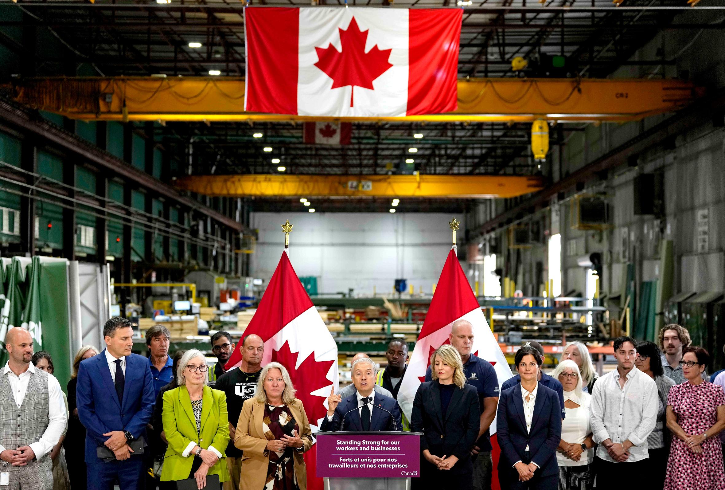 Minister of Finance and National Revenue Francois-Philippe Champagne speaks at a news conference on Canada's response to U.S. tariffs, at a roofing company in Ottawa, on Tuesday, Aug. 25, 2026. (Justin Tang/The Canadian Press via AP)