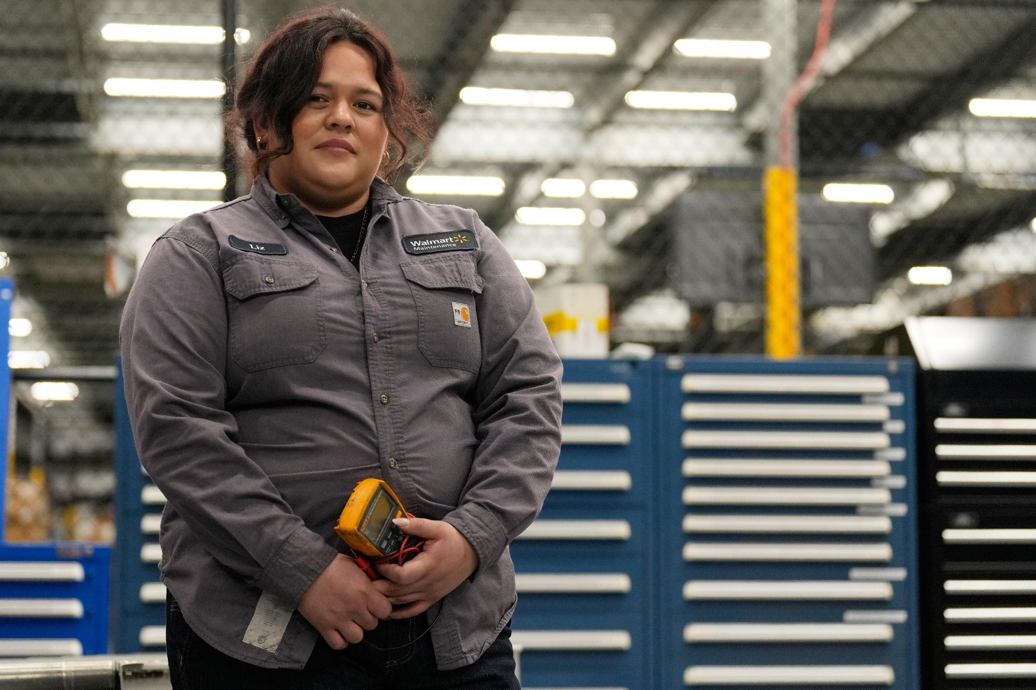 Maintenance technician Liz Cardenas poses for a photo at a training area in a Walmart distribution center Thursday, Sept. 25, 2025, in Bentonville, Ark. (AP Photo/Charlie Riedel)