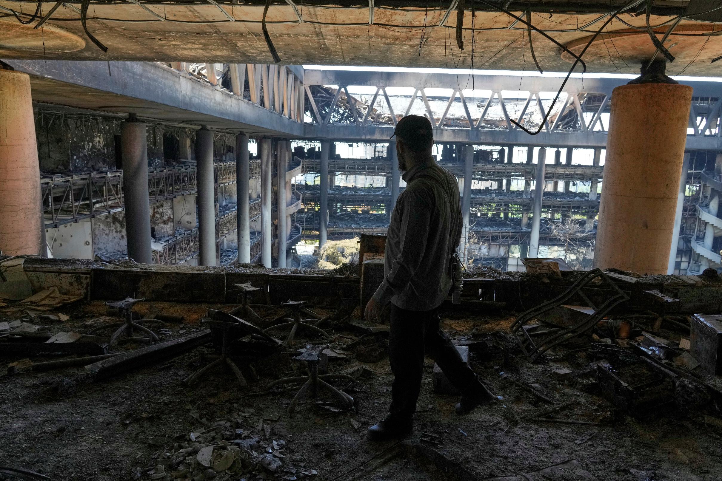 FILE - A man walks in the damaged headquarters of Islamic Republic of Iran Broadcasting, Iranian state television, in Tehran, Iran, Thursday, June 19, 2025. (AP Photo/Vahid Salemi, File)