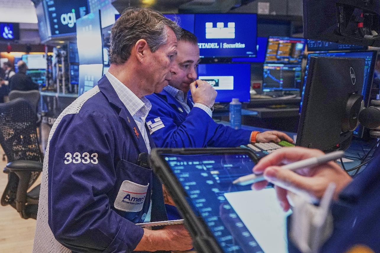 Trader Robert Charmak, left, and Specialist Genarro Saporito work on the floor of the New York Stock Exchange, Wednesday, Feb. 11, 2026. (AP Photo/Richard Drew)