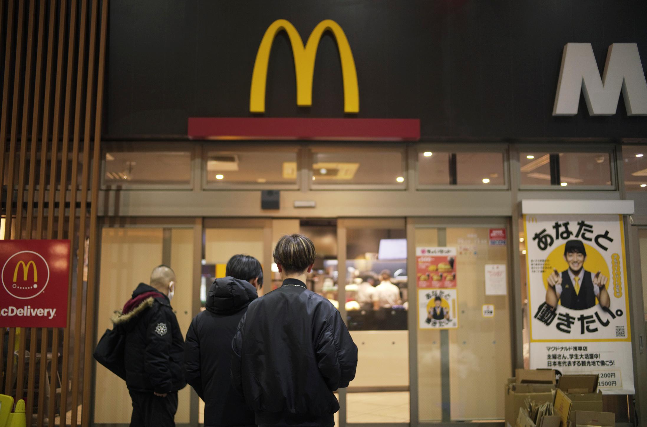 FILE - People stand outside a McDonald's store in Tokyo, March 15, 2024. (AP Photo/Hiro Komae, File)