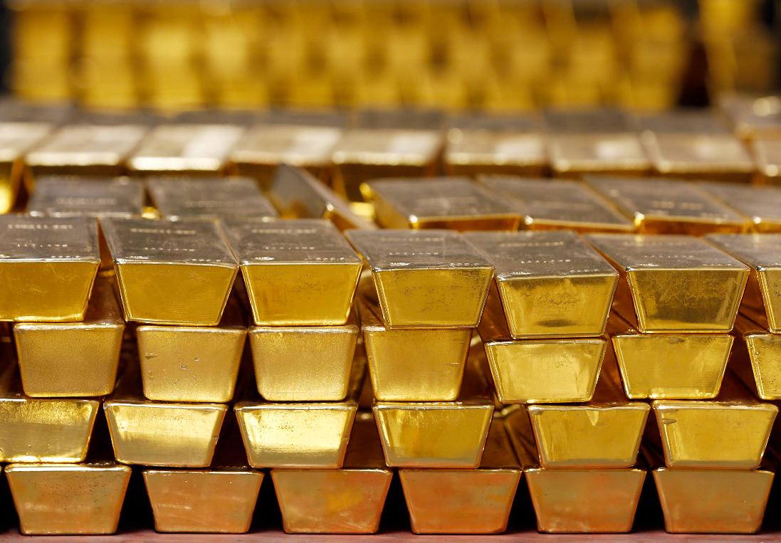 FILE - In this Tuesday, July 22, 2014, file photo, gold bars are stacked in a vault at the United States Mint, in West Point, N.Y. (AP Photo/Mike Groll, File)