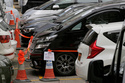FILE - Impounded vehicles meant to be used for Uber service, center, are parked inside the police cordon line at a police station in Hong Kong, Tuesday, May 23, 2017. (AP Photo/Kin Cheung, file)