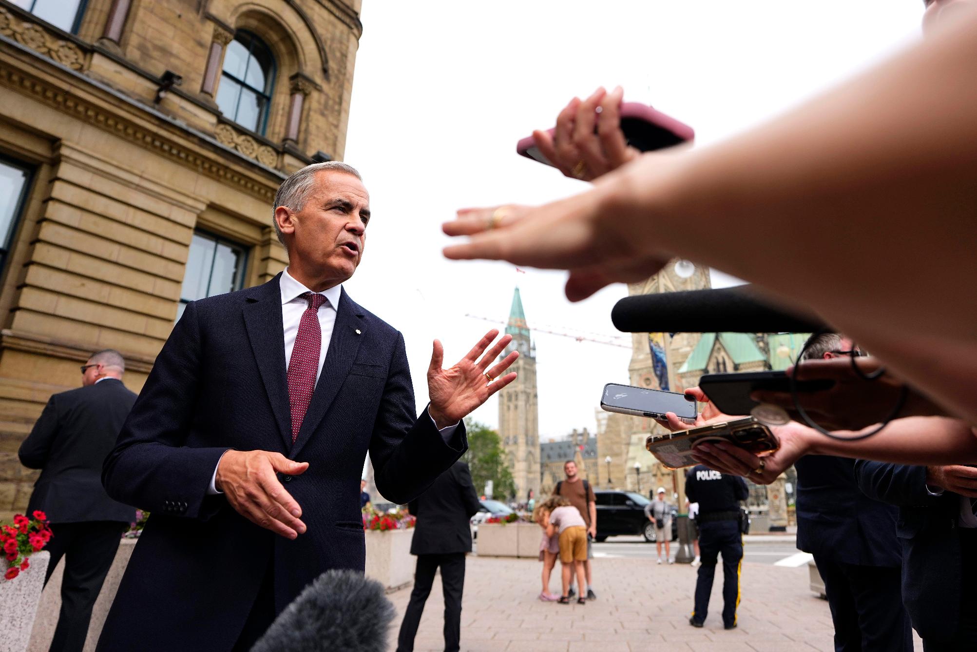 Canada Prime Minister Mark Carney takes questions from journalists after making a statement outside the Office of the Prime Minister and Privy Council in Ottawa, on Tuesday, July 21, 2026. (Justin Tang/The Canadian Press via AP)