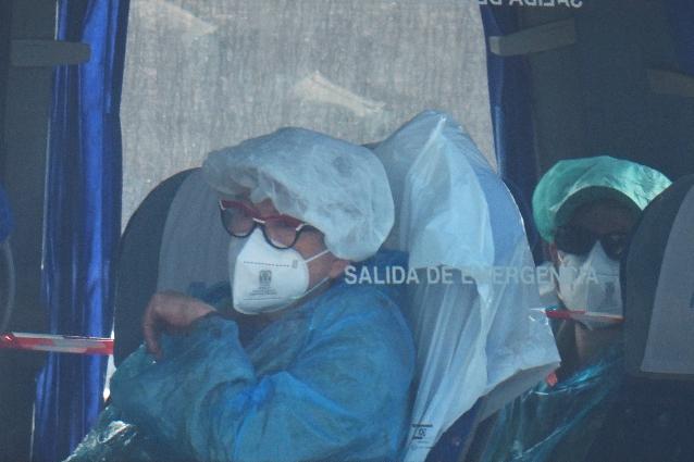 Passengers sit inside a bus after being disembarked from the hantavirus-stricken cruise ship MV Hondius at the port of Granadilla in Tenerife, Canary Islands, Spain, Sunday, May 10, 2026. (AP Photo/Manu Fernandez)