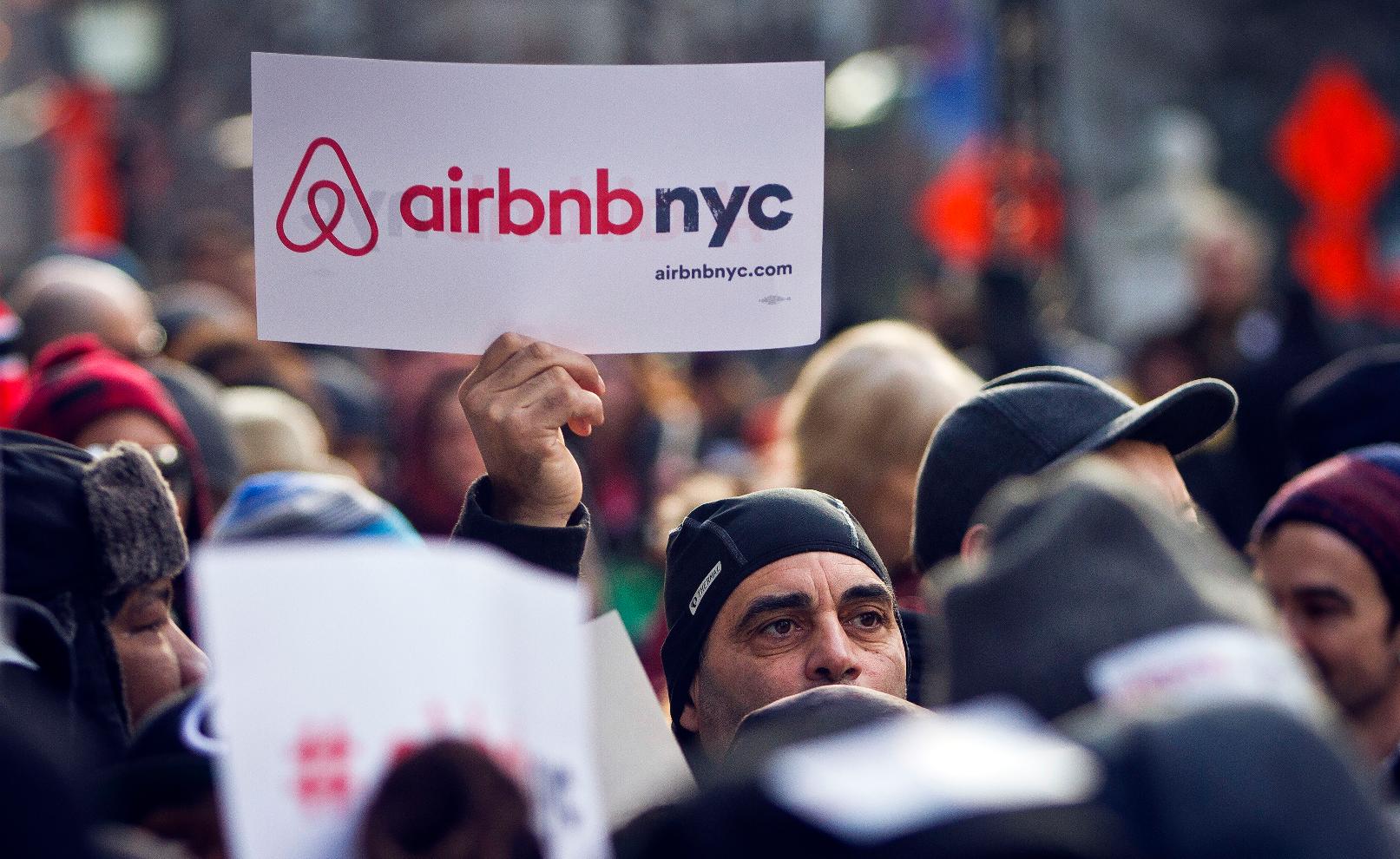 FILE — Supporters of Airbnb hold a rally outside City Hall in New York, Jan. 20, 2015. A New York judge on Tuesday, Aug. 8, 2023 dismissed lawsuits filed by Airbnb and three hosts over New York City's rules for short-term rentals, saying the restrictions are “entirely rational.” (AP Photo/Bebeto Matthews, File)