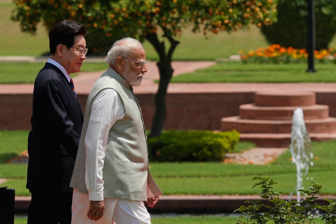 India Prime Minister Narendra Modi and South Korean President Lee Jae Myung walk to plant sampling of an Ashoka tree in New Delhi, India, Monday, April 20, 2026. (AP Photo/Manish Swarup)