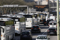 Protesting truck and bus drivers slow traffic down along Paris' ring road to denounce higher fuel prices, Monday, March 30, 2026. (AP Photo/Thibault Camus)