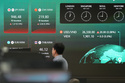 A dealer walks past near the screens showing the foreign exchange rates at a dealing room of Hana Bank in Seoul, South Korea, Wednesday, May 13, 2026. (AP Photo/Lee Jin-man)