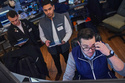 Joseph Lawler, right, works with fellow traders on the floor of the New York Stock Exchange, Thursday, April 23, 2026. (AP Photo/Richard Drew)