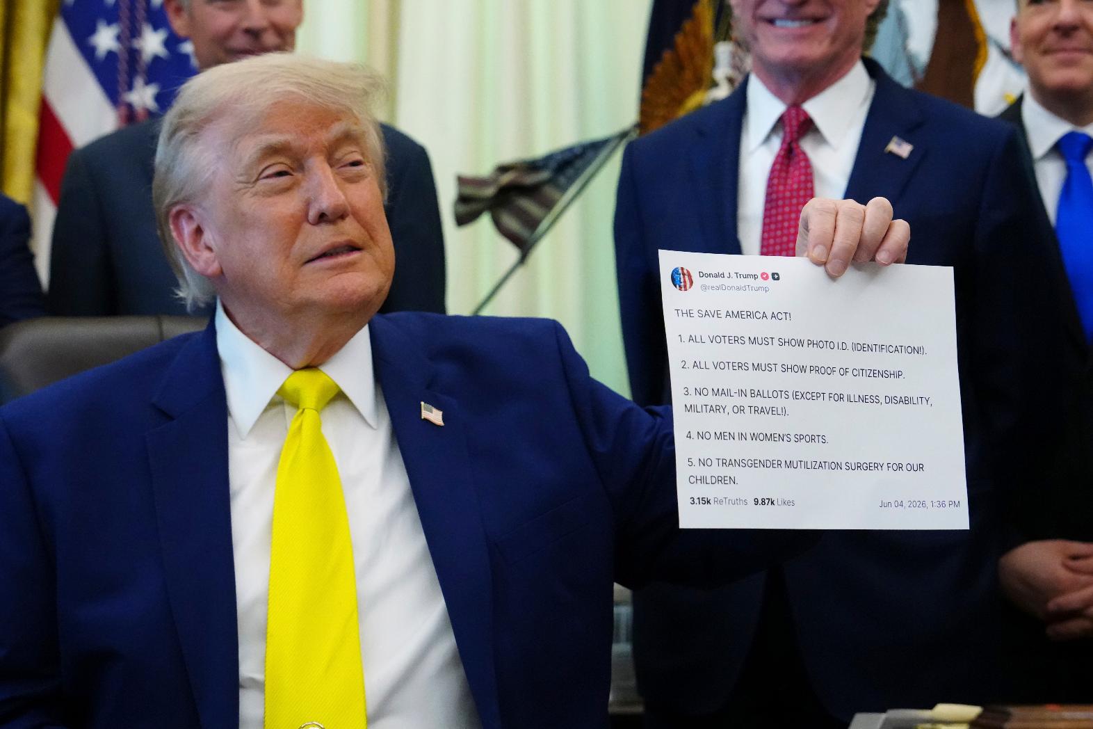 FILE - President Donald Trump holds up an image taken from his Truth Social account at an event about coal, Thursday, June 4, 2026, in the Oval Office of the White House in Washington. (AP Photo/Julia Demaree Nikhinson,File)