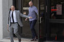 Assistant U.S. Attorney Logan Liles, left, leaves the federal courthouse in Raleigh, N.C., on Friday, April 24, 2026, during the case of Gannon Ken Van Dyke, a soldier who is charged with using his access to classified information about the operation to capture Venezuelan President Nicolas Maduro in January to win money on Polymarket. (AP Photo/Allen G. Breed)