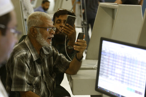 Pakistani brokers react while they monitor Index on their mobile phone at at the Pakistan Stock Exchange (PSE), in Karachi, Pakistan, Friday, June 24, 2022. Pakistan's stock market suddenly fell by three percent on Friday, shortly after the government of recently elected Prime Minister Shahbaz Sharif suddenly announced the imposition of additional taxes on the corporate and banking sector in an effort aimed at stabilizing the country's fledgling economy. (AP Photo/Fareed Khan)