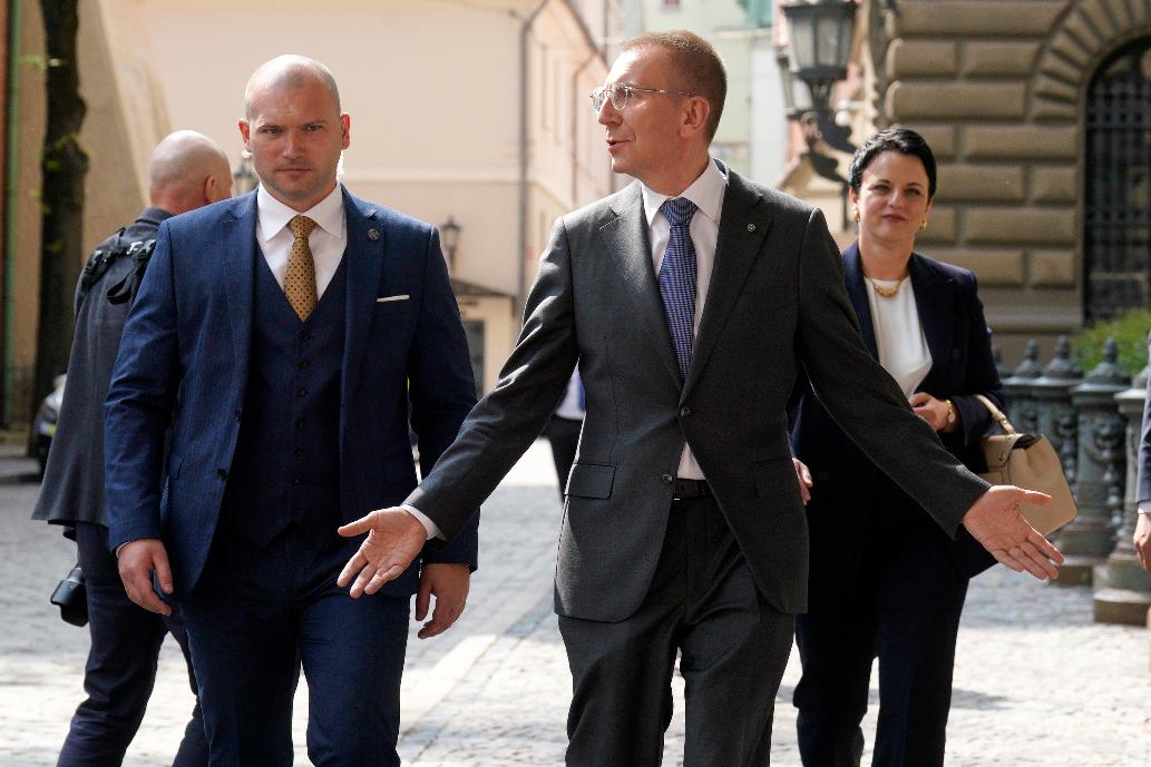 Newly elected Latvian President Edgars Rinkevics, centre, gestures as he walks outside of the parliament building after lawmakers elected him in Riga, Latvia, Wednesday, May 31, 2023. (AP Photo/Roman Koksarov)