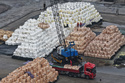 Workers transfer bags of imported solid sulfur onto a truck in a port in Nanjing in eastern China's Jiangsu province, Tuesday, April 14, 2026. (Chinatopix Via AP) CHINA OUT