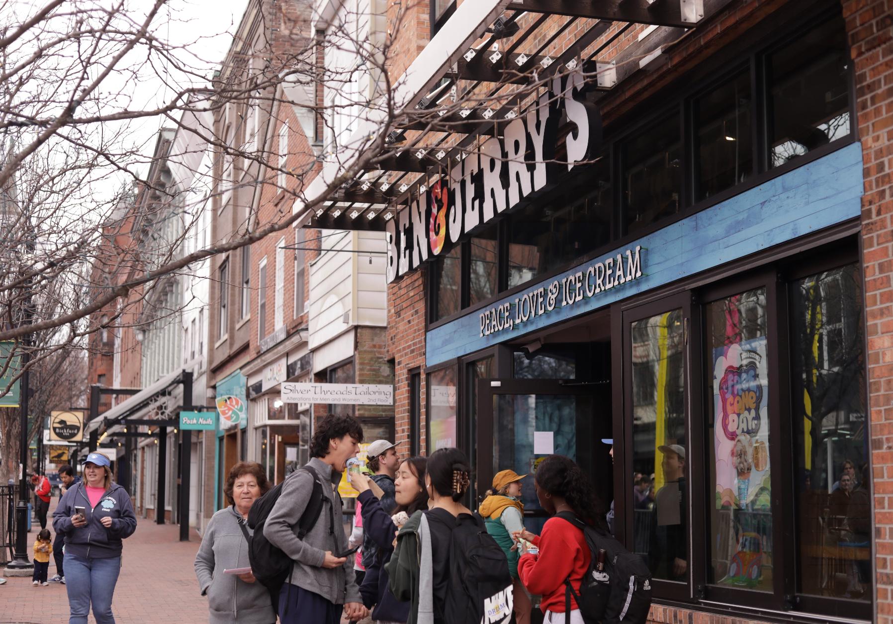 People eat ice cream outside the Ben and Jerry's scoop shop on Free Cone Day on Free Cone Day in Burlington, Vt., Tuesday, April 14, 2026. (AP Photo/Amanda Swinhart)