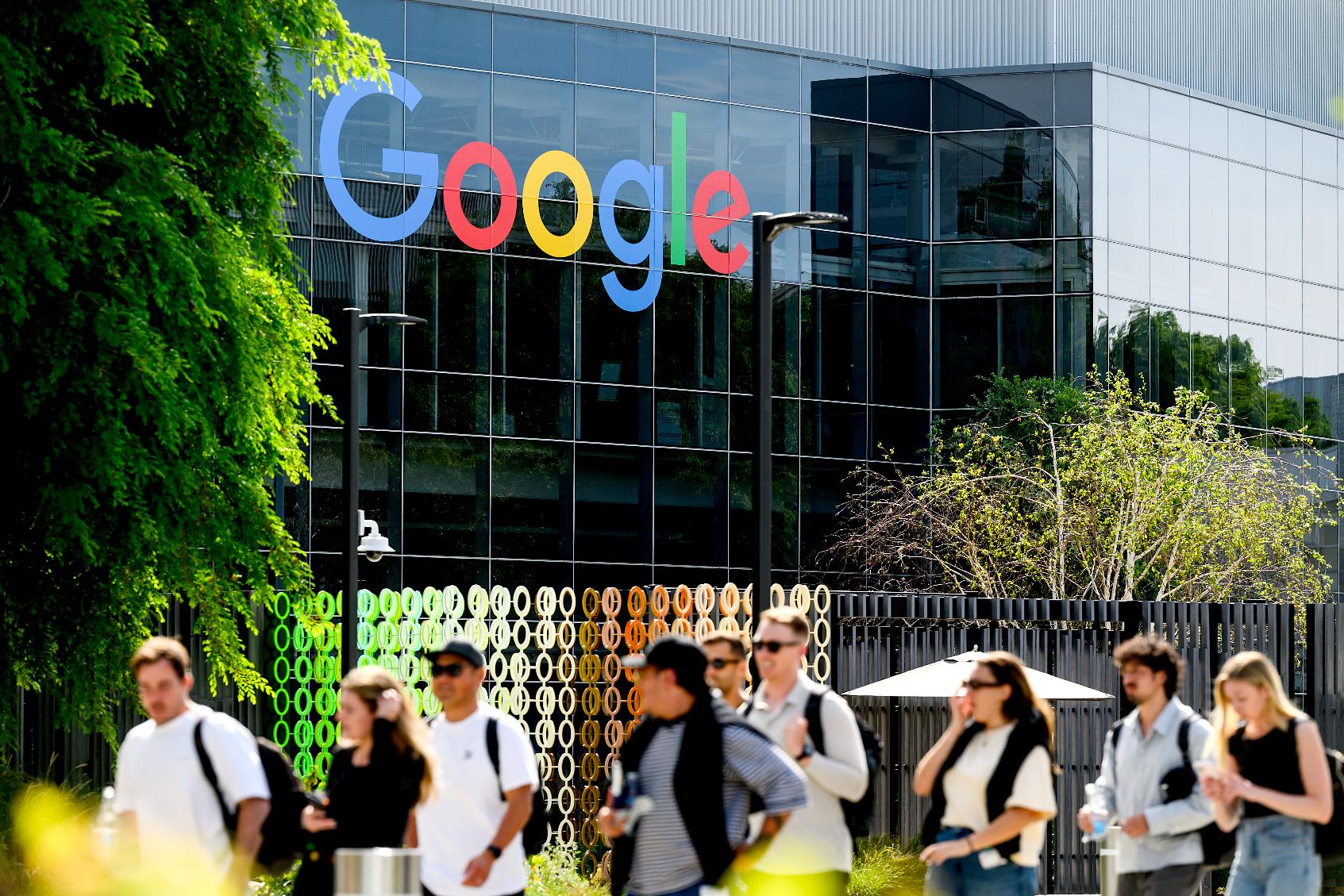 People walk through Google headquarters in Mountain View, Calif., on Thursday, March 26, 2026. (AP Photo/Noah Berger)