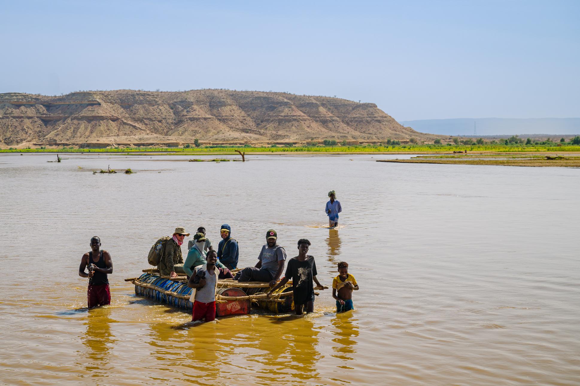 Myrrh researchers cross the Shebelle River with the help of boatmen that wade in the low levels instead of paddling as they make their way toward East Imi, Ethiopia, Saturday, Jan. 10, 2026. (AP Photo/Julianne Gauron)