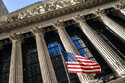 A U.S. flag waves outside the New York Stock Exchange, Monday, Jan. 24, 2022, in New York. Stocks are falling again in early trading on Wall Street, Friday, Jan. 28, continuing a miserable opening to the year for markets that has put the S&P 500 on track for its fourth straight weekly loss. (AP Photo/John Minchillo)