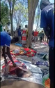 In this image made from video, dead bodies are seen covered on the ground, after gunmen killed more than 70 people in South Sudan over a gold mining row on the outskirts of the capital, in Jebel Iraq, South Sudan, Sunday, March 29, 2026. (Aweil News Agency via AP)