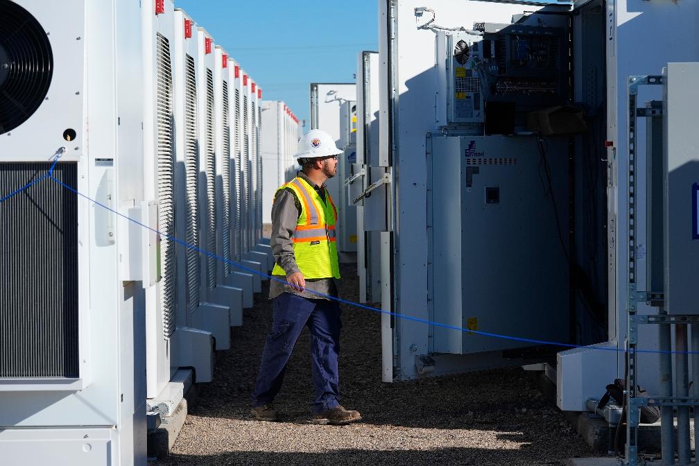 FILE - A worker does checks on battery storage pods at Orsted's Eleven Mile Solar Center lithium-ion battery storage energy facility Feb. 29, 2024, in Coolidge, Ariz. (AP Photo/Ross D. Franklin, File)