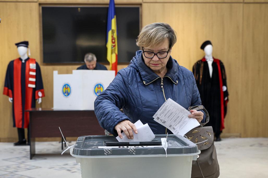 A woman casts her vote during local elections in Chisinau, Moldova, Sunday, Nov. 5, 2023. Moldovans will cast ballots in nationwide local elections on Sunday amid claims by Moldovan authorities that Russia has been conducting a "hybrid warfare" to undermine the vote in the European Union candidate country. (AP Photo/Aurel Obreja)