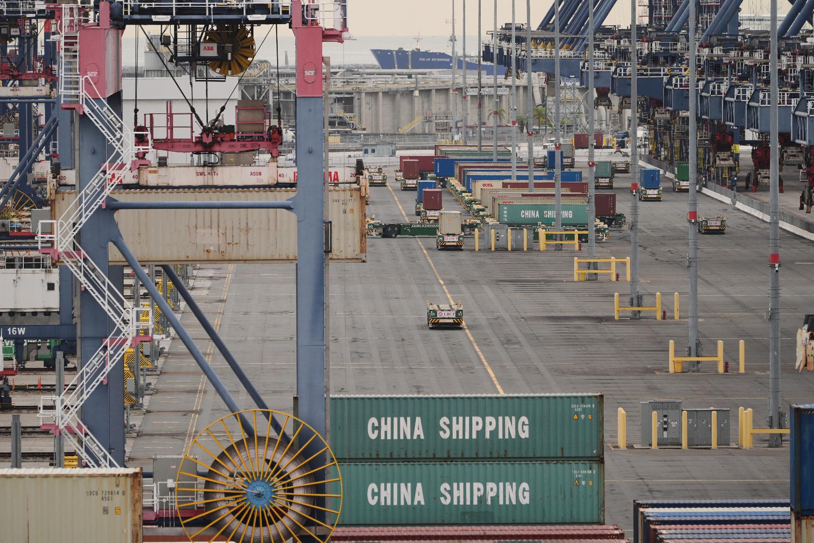 Containers are stacked at the Port of Long Beach Friday, Feb. 20, 2026, in Long Beach, Calif. (AP Photo/Damian Dovarganes)
