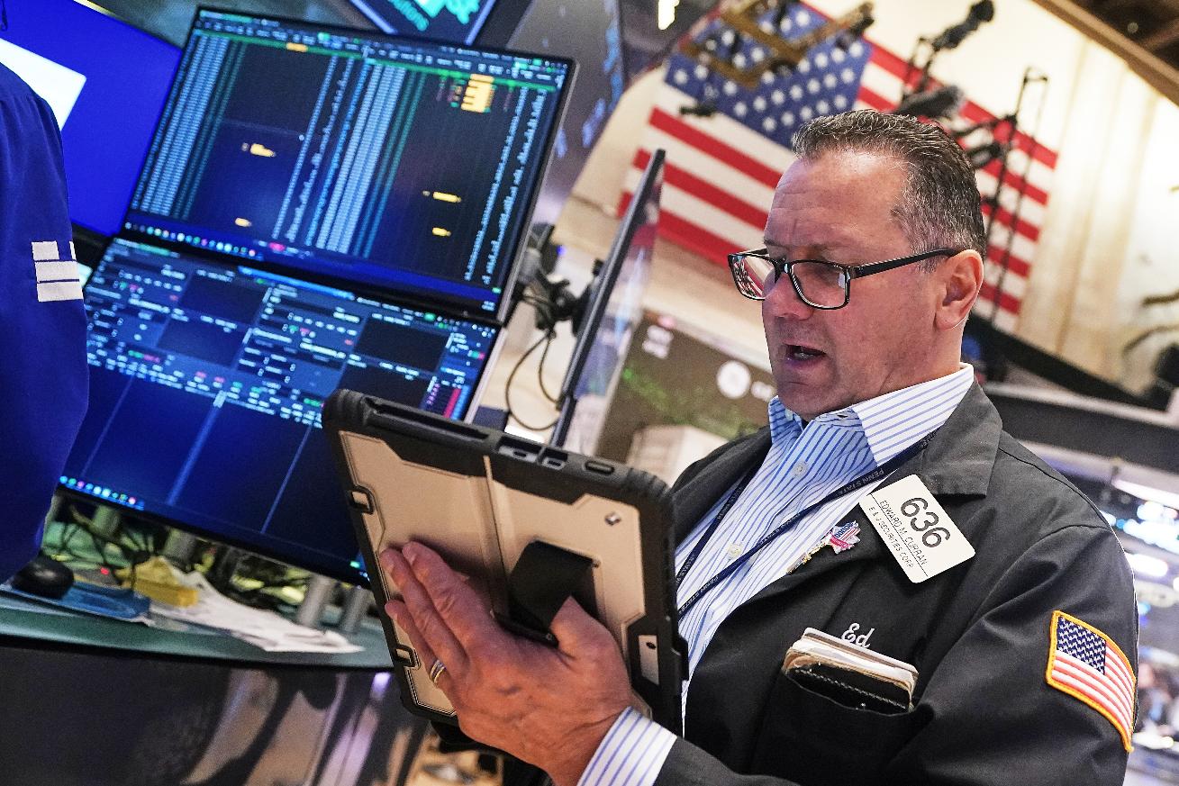 Trader Edward Curran works on the floor of the New York Stock Exchange, Wednesday, April 22, 2026. (AP Photo/Richard Drew)