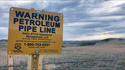 FILE - A sign for the Dakota Access Pipeline is seen north of Cannonball, N.D. and the Standing Rock Reservation on May 20, 2021. (AP Photo/Matthew Brown, File)